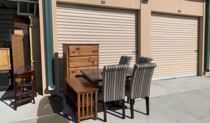 A table and chairs outside of a store