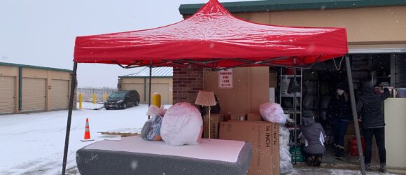 A red tent is set up to cover the mattress.