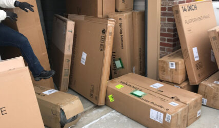 A person is moving boxes into the garage.