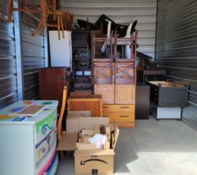 A storage unit filled with boxes and furniture.