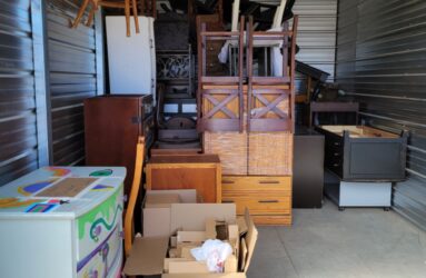 A storage unit filled with boxes and furniture.
