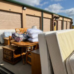 A table and chairs in front of storage units.